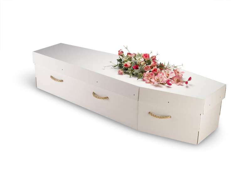 White cardboard coffin and flowers