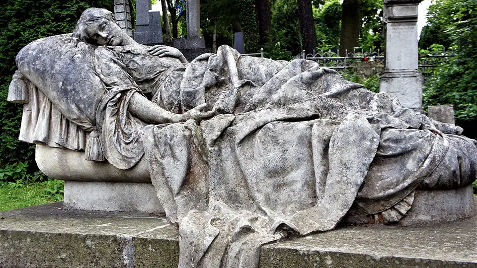 Elegant stone woman on stone bed