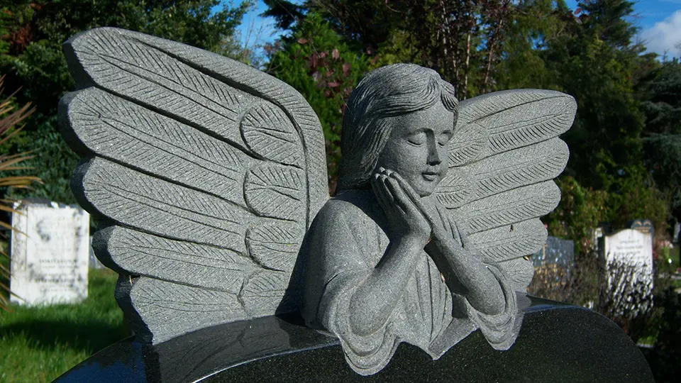 Stone angel set into headstone