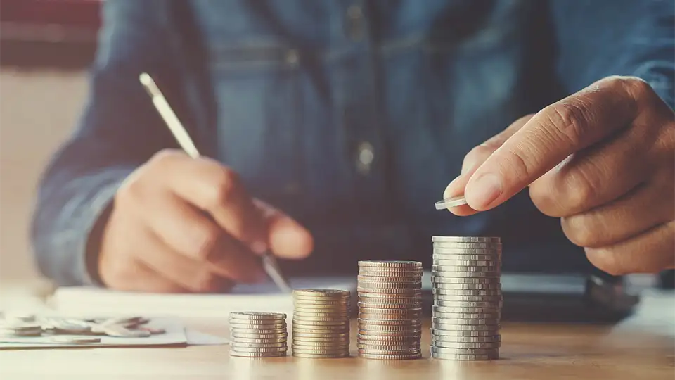 Man with coin piles