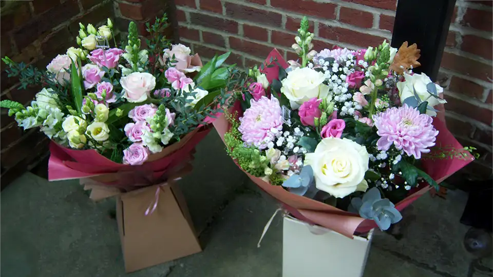 Two bright flower arrangements in pots