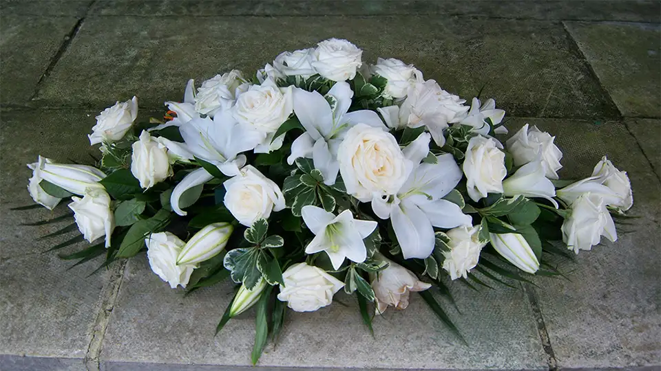 White rose and lilley funeral flower spray