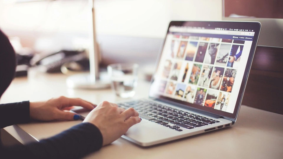 Woman looking at images on a laptop pc